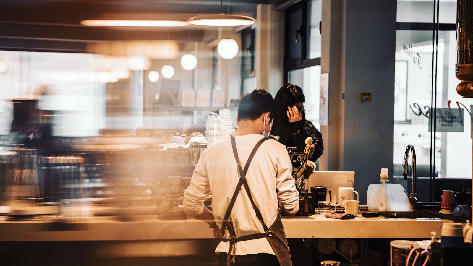 A restaurant manager reviewing paperwork at a table before service, documenting an employee write up the right way